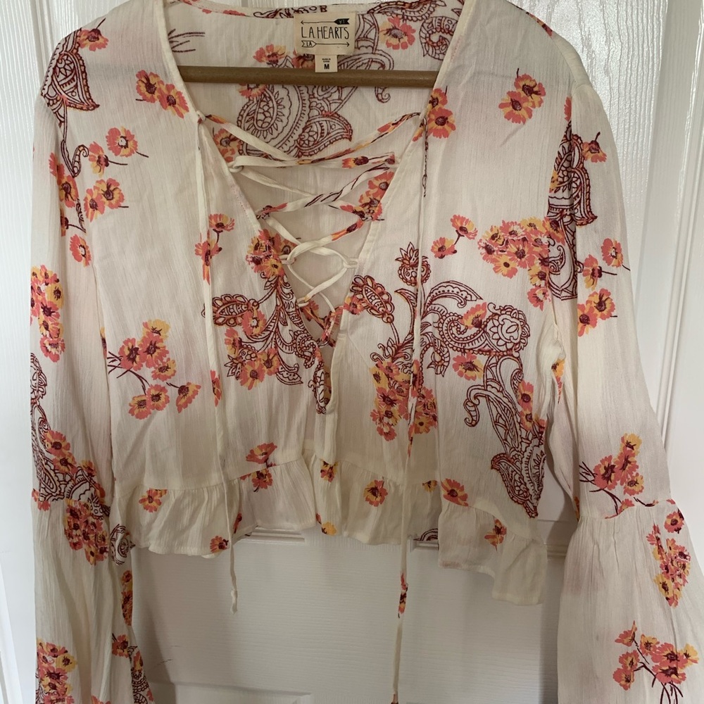 Crop top with bell sleeves and lace up front.